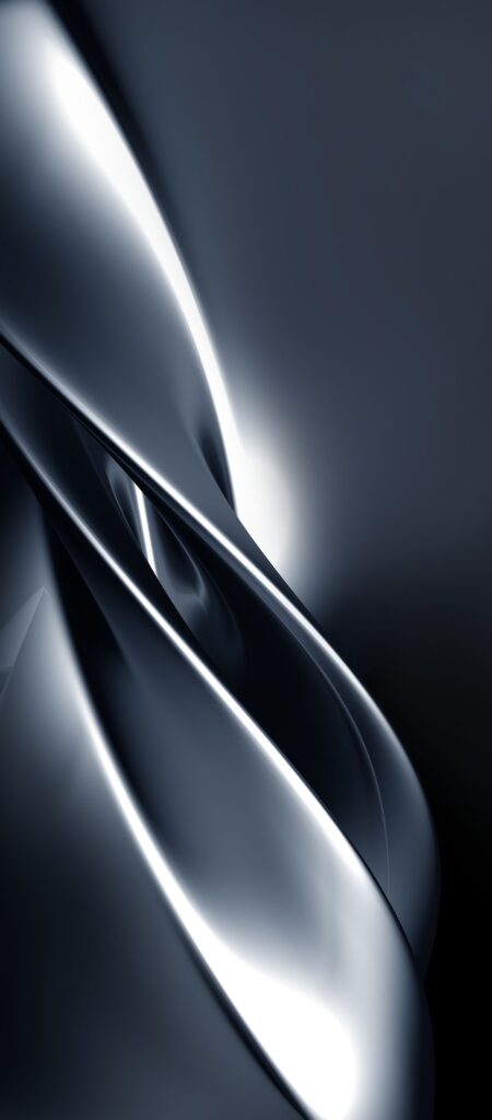 Abstract image featuring sleek, intertwined metallic curves with a glossy surface. The composition is primarily in shades of gray, creating a smooth and flowing aesthetic. Bright highlights accentuate the reflective texture.
