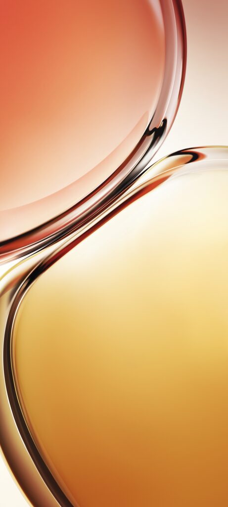 Close-up of two glass-like, abstract shapes blending together, one in warm orange and the other in golden yellow. The smooth, curved surfaces create a fluid and dynamic composition with soft lighting.
