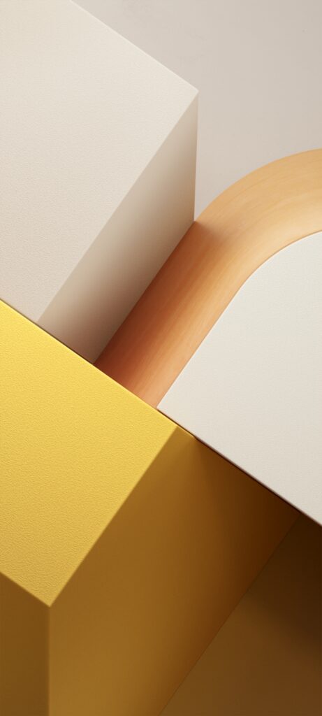 Abstract image featuring three intersecting 3D geometric shapes. A yellow rectangular block, a cream rectangular block, and a smooth curved wooden piece are arranged in a minimalist composition against a neutral background.
