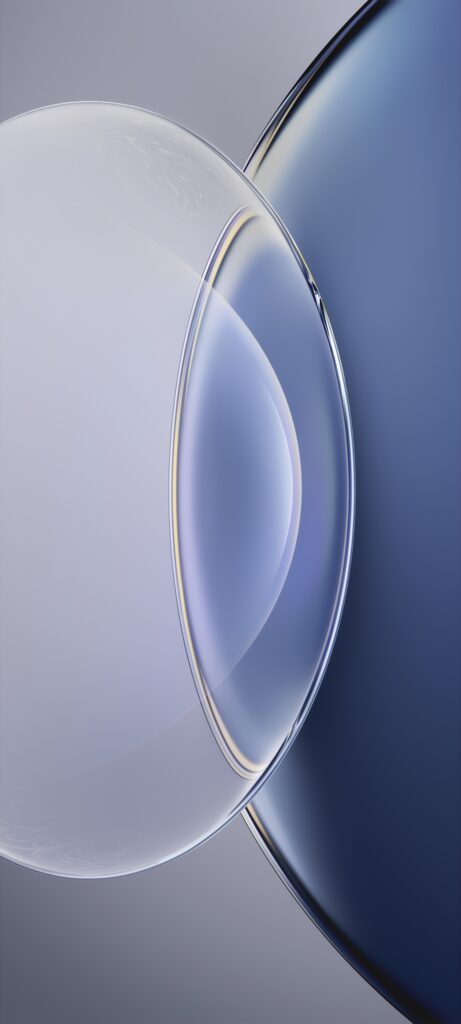 Abstract image of two overlapping transparent discs with a glossy, reflective surface. The left disc is light gray and the right disc is dark blue, creating a gradient effect in the overlapping area. The background is softly blurred.
