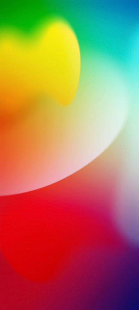 A vibrant abstract image featuring a gradient of bright colors including green, yellow, red, blue, and purple. The colors blend smoothly, creating a soft, fluid appearance without defined shapes or lines.
